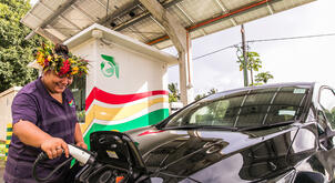 In Papua New Guinea, an operator plugs in an electric car, using eco-friendly transportation based on renewable energy and fostering greater energy-independence on the islands. 